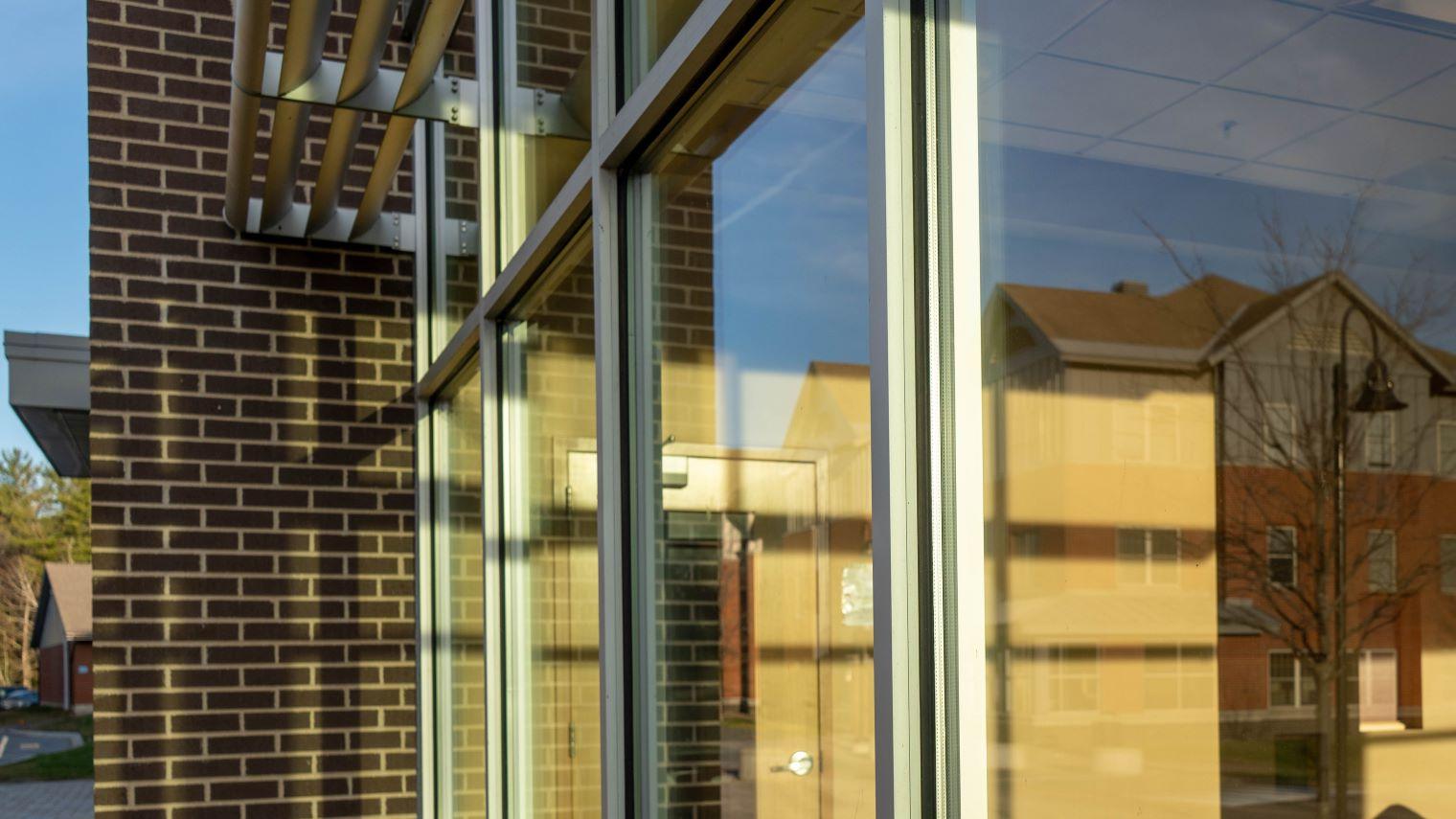 Reflection in a window showing another residence hall